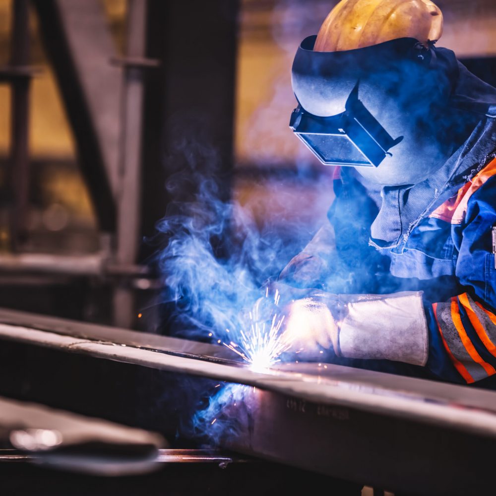 Worker welding in a factory. Heavy industry, welder work